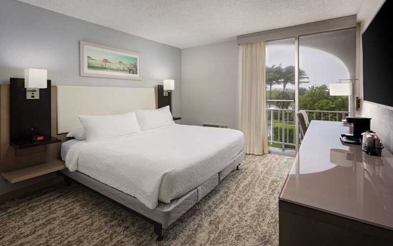 king size bed guest room with view at fairfield inn suites palm beach