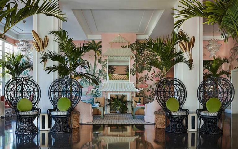 lobby interior with palms and wicker chairs at the colony palm beach