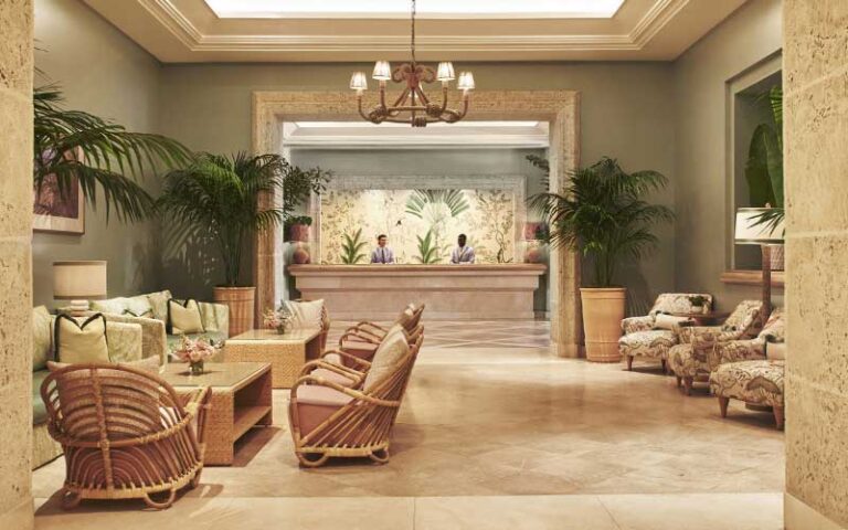 lobby with front desk and stone pillars at the four seasons palm beach