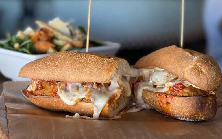 meatball sub halves with salad in background at lynoras kitchen west palm beach