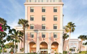 pink stately hotel building exterior street view at the colony palm beach
