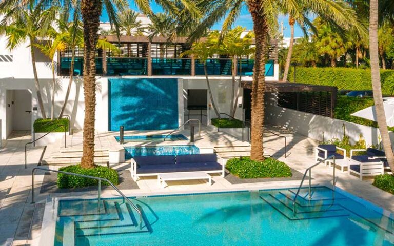 pool area cabanas and fountain at tideline palm beach ocean resort spa