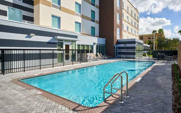 pool patio area beside hotel at fairfield inn suites by marriott west palm beach