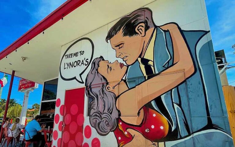 pop art mural take me to lynoras couple on side of building at lynoras kitchen west palm beach