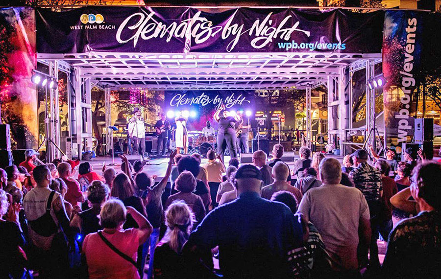 purple lighted concert stage with band performing music at clematis by night west palm beach