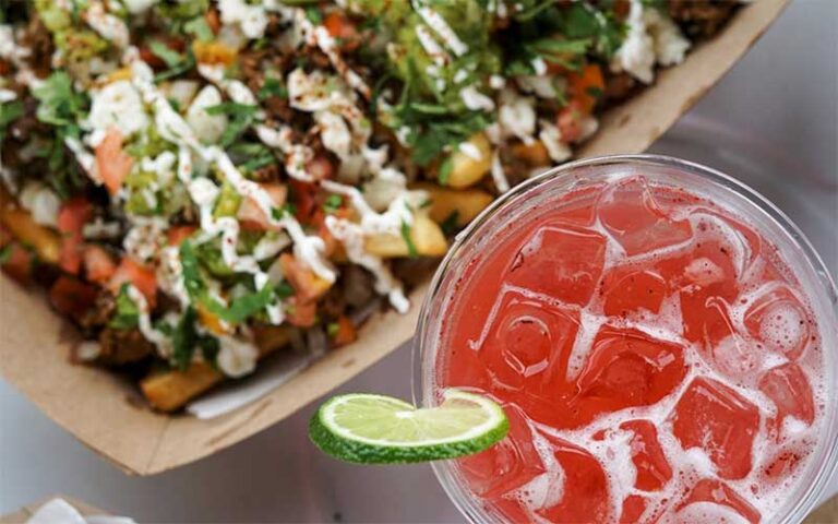 red fruity cocktail with ice and lime and mexican entree salad at grandview public market west palm beach