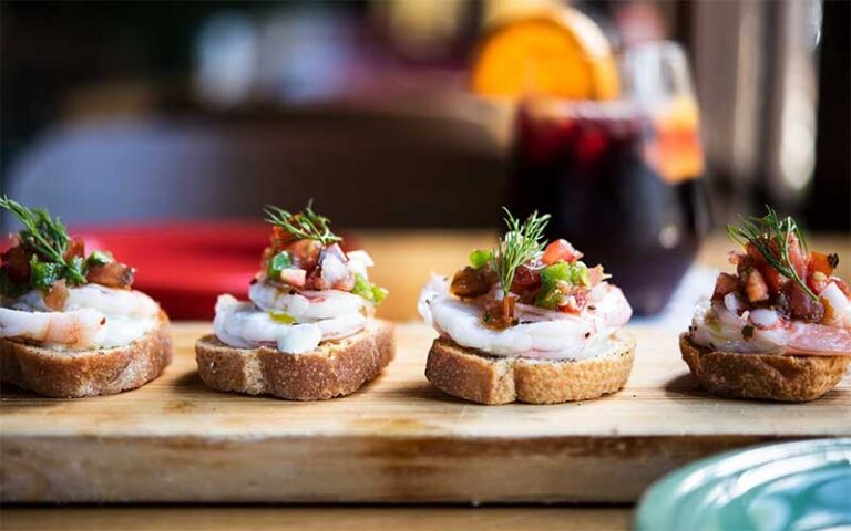 row of flatbread tapas with shrimp at cafe tu tu tango orlando