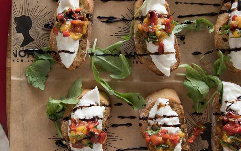 special pepper bruschetta on brown paper and tray at lynoras kitchen west palm beach