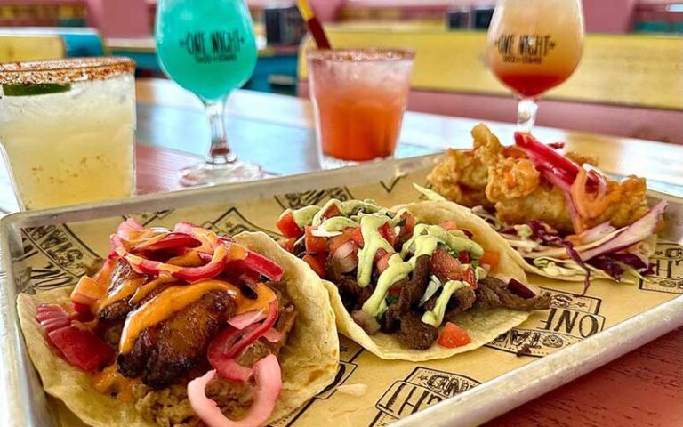 specialty tacos with drinks on tabletop at one night taco stand jacksonville
