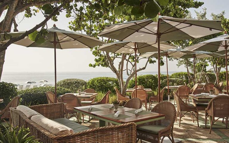 terrace dining area with tables and ocean view at the four seasons palm beach