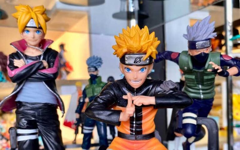 three character figurines on display shelf at anime world orlando