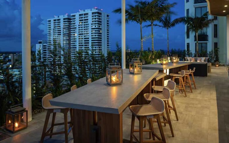 treehouse patio dining seating on balcony at night at canopy by hilton west palm beach downtown