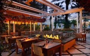 twilight outdoor patio dining with fire pit at galley west palm beach