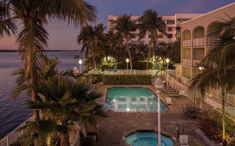 twilight view of pool area between hotel and water at fairfield inn suites palm beach