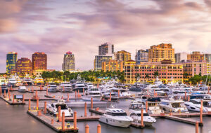 view across intracoastal with marina yachts and sailboats and downtown skyline west palm beach