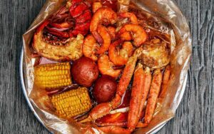 view over large seafood boil pot with seasoned items at mr mrs crab juicy seafood bar orlando kirkman