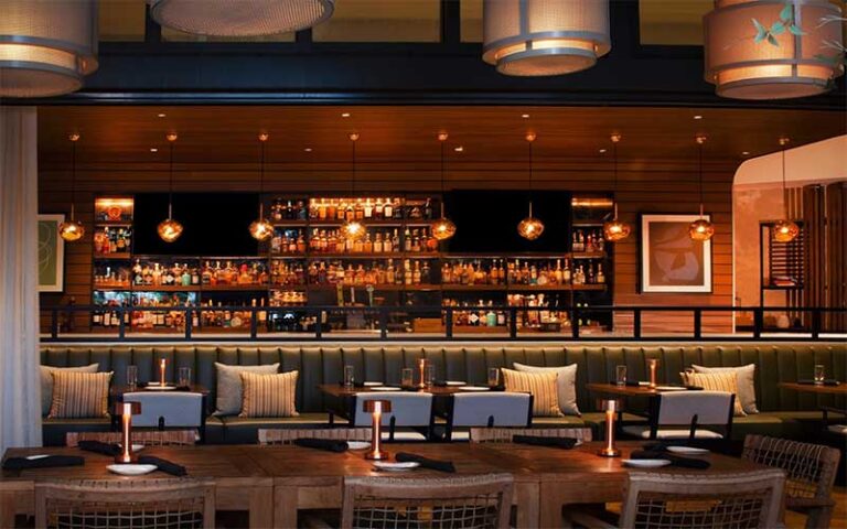 warm interior bar with bottles and seating at galley west palm beach