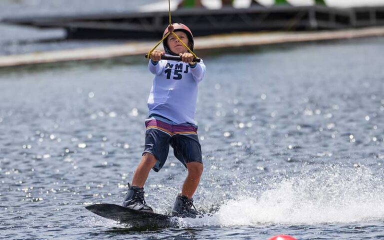 young boy wakeboarding on cable at nona adventure park orlando