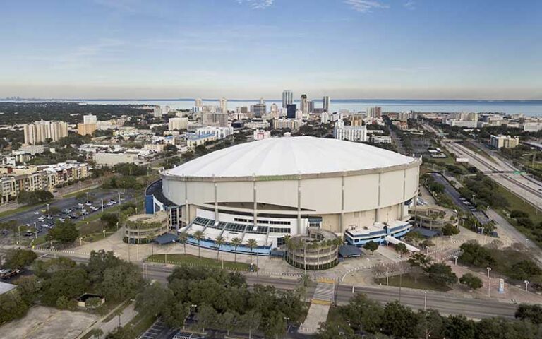 aerial view of white domed stadium with cityscape and bay at tropicana field st pete