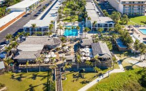 aerial view over beach of hotel with tiki bar at the beachcomber st pete beach