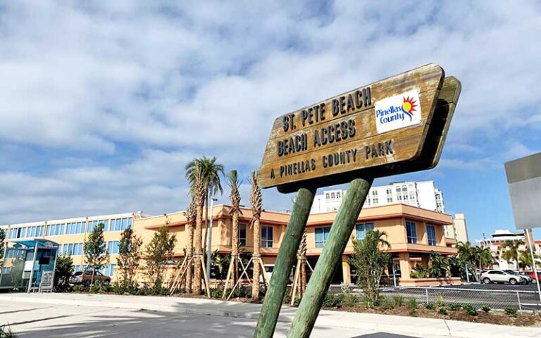 beach access sign with resort and parking at st pete beach