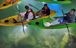 clear bottom kayaks with led lights over rocks at night at sharkeys glass bottom tours st pete beach