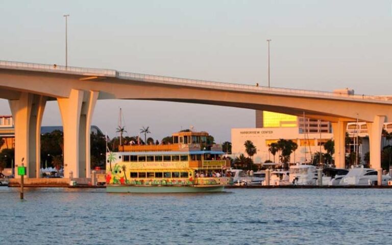 colorful cruise boat sailing under bridge at calypso queen clearwater