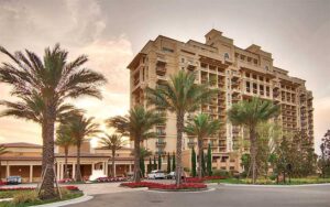 dawn exterior of high rise hotel with palms at four seasons resort orlando walt disney world
