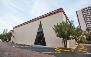 daytime exterior of building in city with triangular window opening at the florida holocaust museum st pete