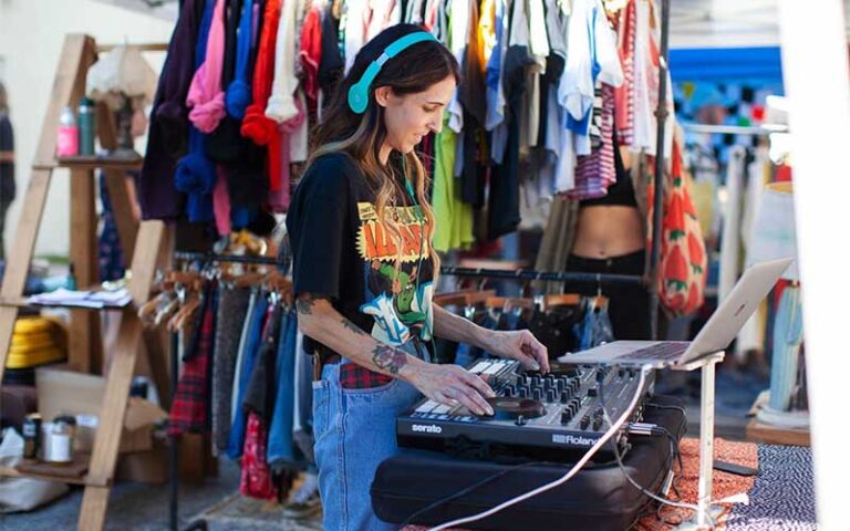 dj playing music in clothing booth at st pete indie flea