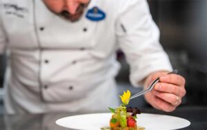 entree with chef adding garnish at victoria alberts at grand floridian walt disney world resort orlando