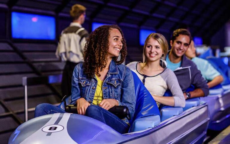 excited riders seated in coaster on space mountain at magic kingdom walt disney world resort orlando