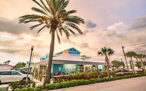 exterior street view of blue restaurant with palm tree at the original crabby bills indian rocks beach