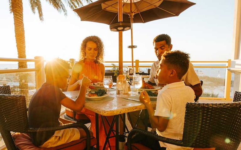 family dining on patio with sunrise at sandpearl resort clearwater beach