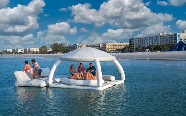family on inflatable cabana with beach and resort in background at island grand resort st pete beach