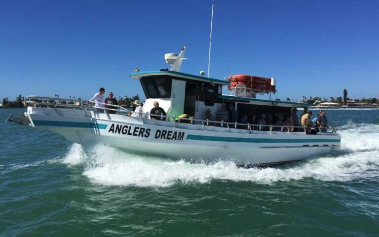 fishing charter boat moving through choppy waves at dolphin landings charter boats st pete beach