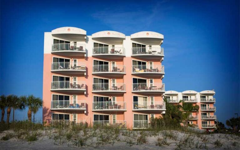 five story pink balconies of hotel on beach at beach house suites st pete
