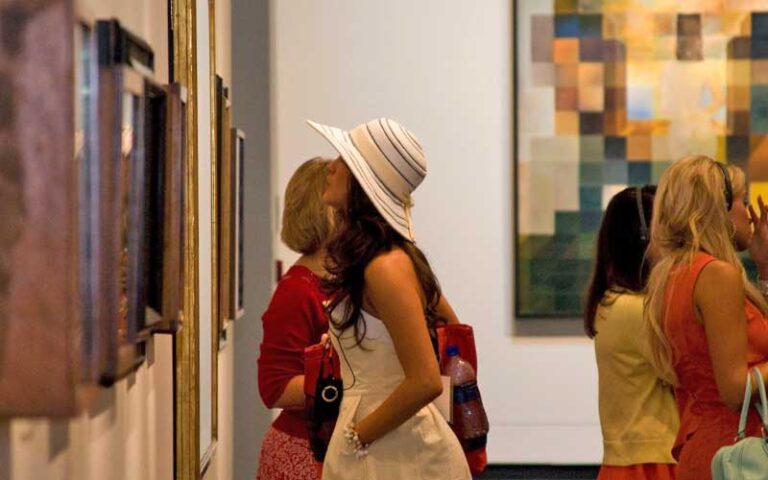 group of ladies looking at paintings in exhibit room at salvador dali museum st pete