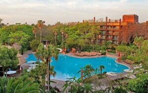 hotel with pool area shrouded in trees at disneys animal kingdom resort walt disney world orlando