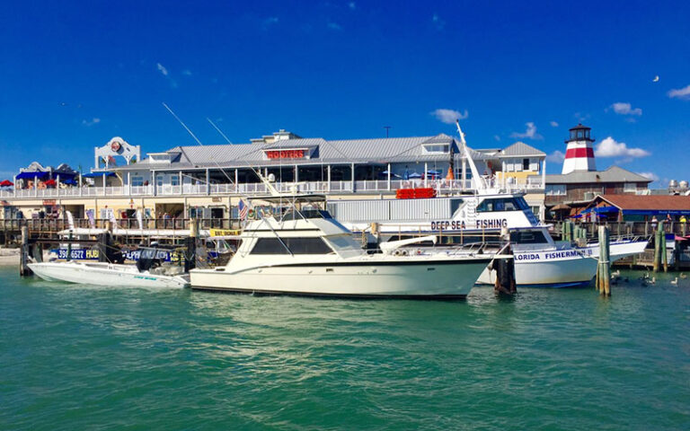 hubbards marina with boats on blue water at johns pass village boardwalk madeira beach