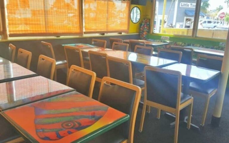 interior dining deck with colorful tables and chairs at calypso queen clearwater