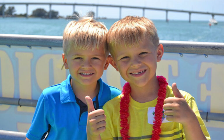 kids smiling with thumbs up on boat at the tropics boat tours clearwater beach