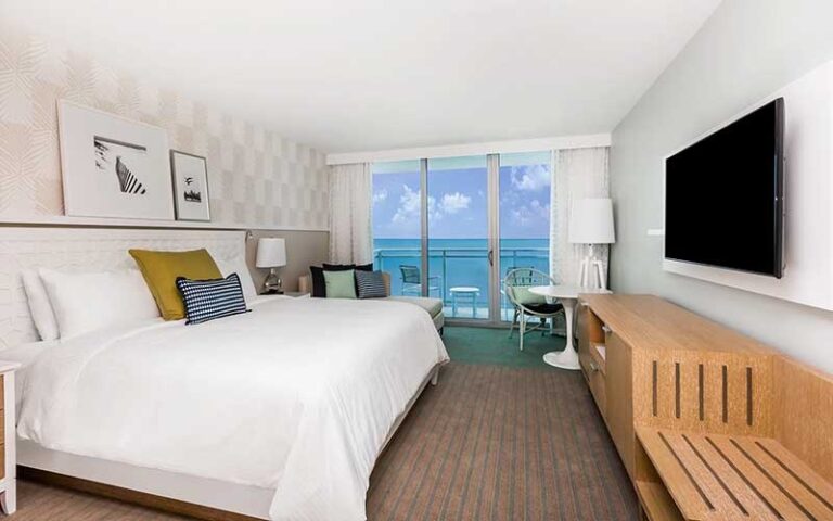 king size bed guestroom with ocean view at wyndham grand clearwater beach
