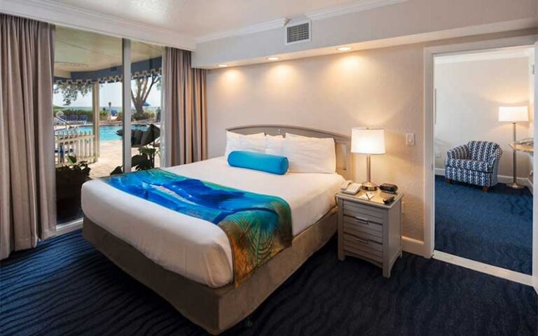 king size guestroom with pool access at rumfish beach resort st pete