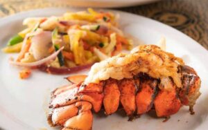 lobster tail with tropical slaw plated at seabreeze island grill st pete clearwater