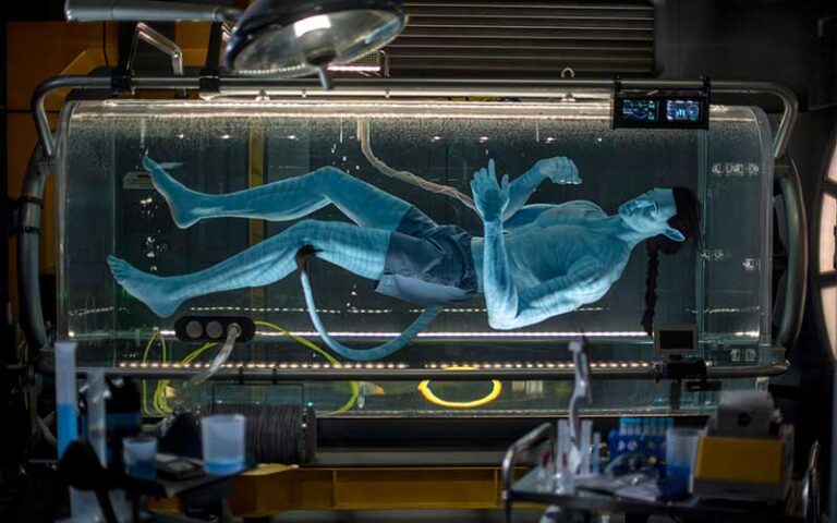 navi man in float tank inside lab on avatar flight of passage at animal kingdom walt disney world resort