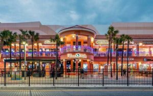 night exterior pink two story shopping center at pelican walk plaza clearwater beach