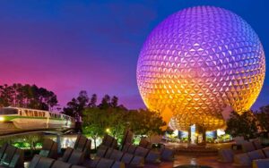 night lighted spaceship earth with monuments and monorail at epcot walt disney world resort orlando