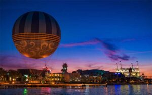 night view from water of entertainment area with balloon ride and cirque de soleil at disney springs walt disney world resort orlando