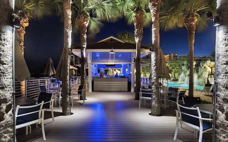 night view of outdoor dining poolside with waterfall at clearwater beach marriott suites on sand key